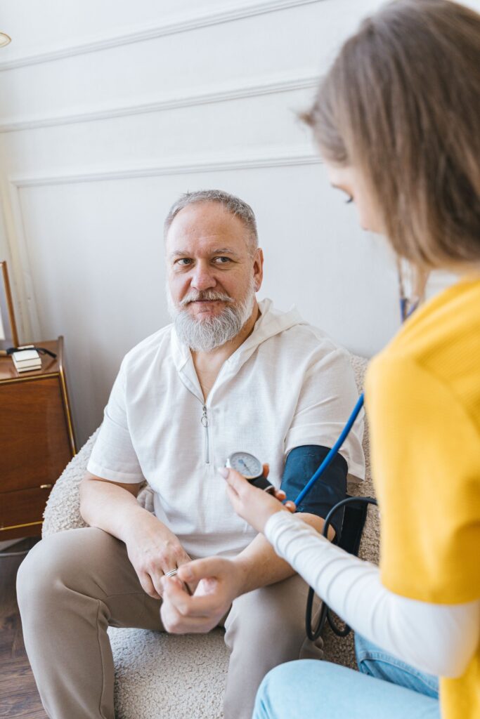 Blood pressure check with an older man