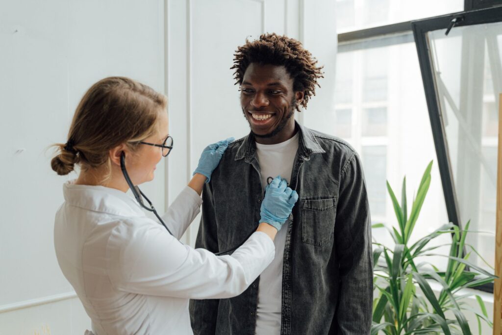 Doctor with stethoscope and smiling patient